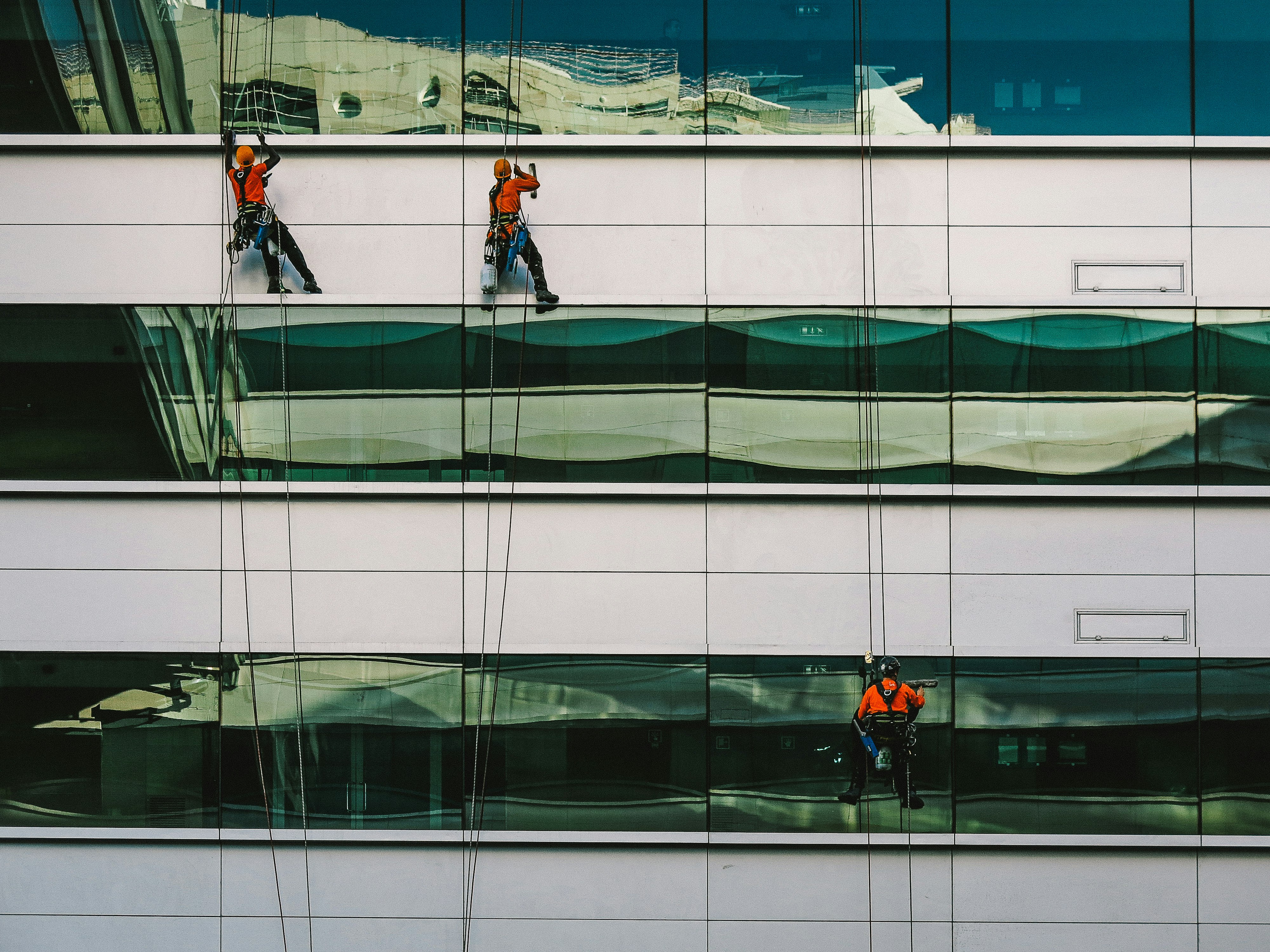 man cleaning white building